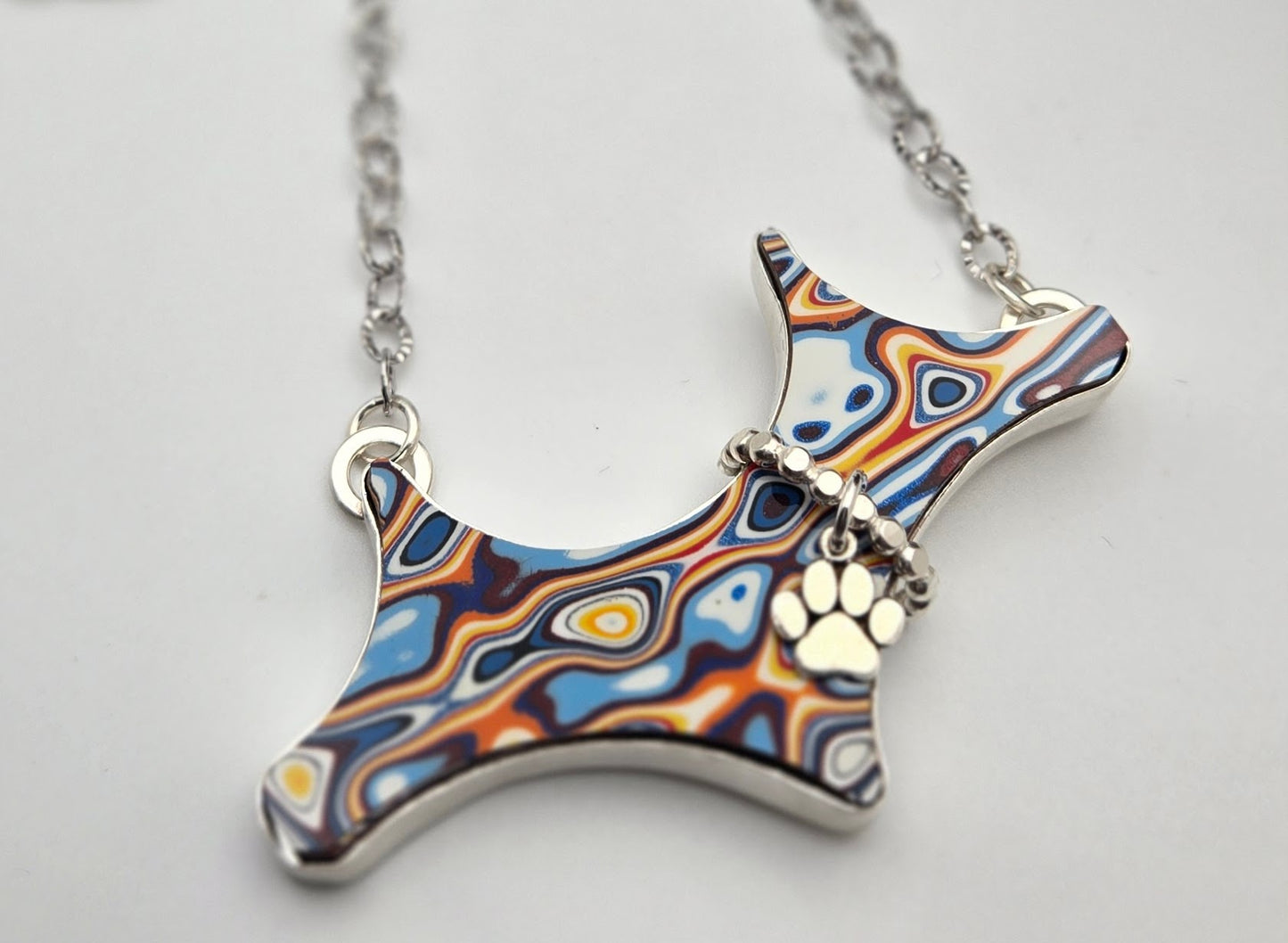 Felicia, the Fordite pup necklace