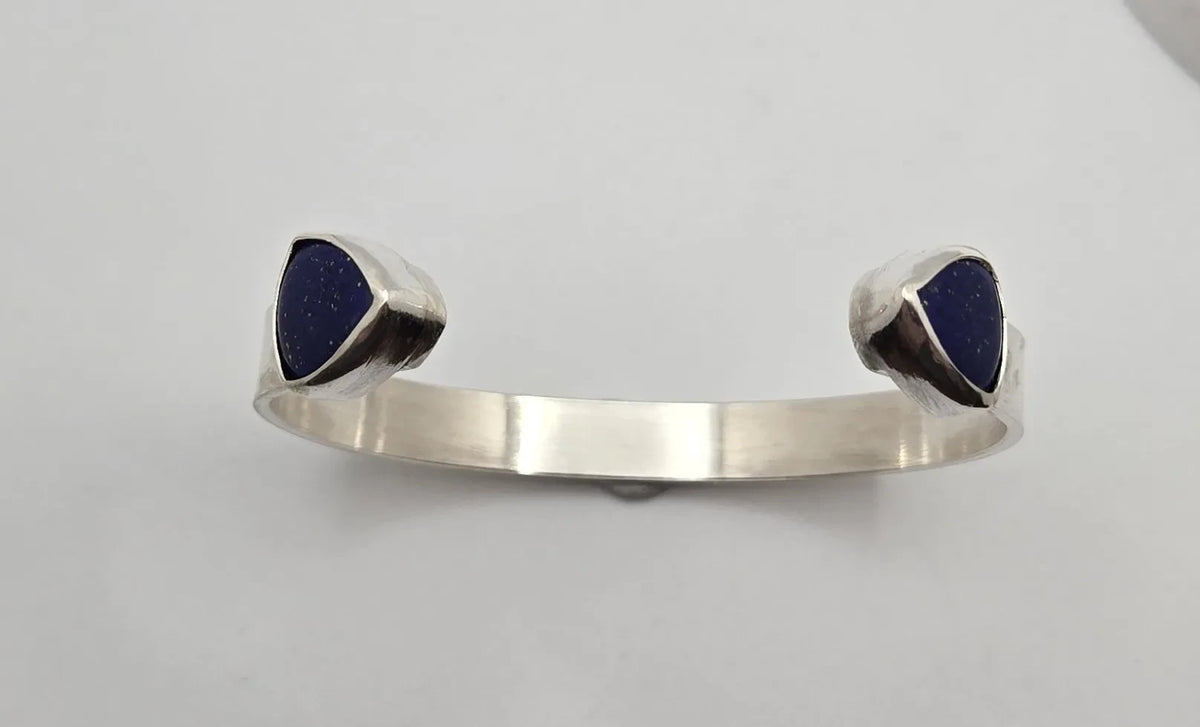 Blue Teapot Jewelry sterling silver cuff bracelet with triangular midnight-blue lapis lazuli stones at each end.