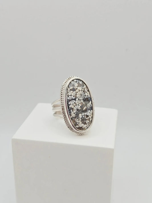 Blue Teapot Jewelry oval statement ring featuring a fossil coral inlay in grey and white with a beaded sterling silver bezel.